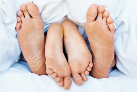 Couple having sex on blue sheets