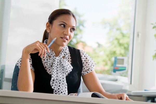 Woman daydreaming at work