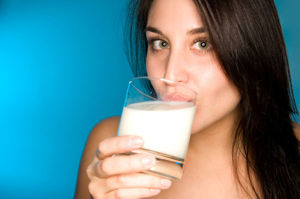 Woman drinking milk from osteoporosis