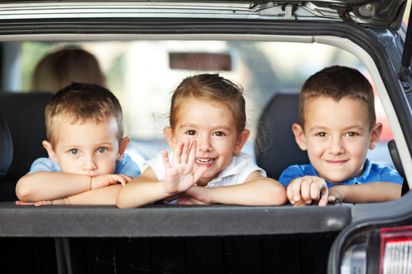 Happy kids in the back of a car