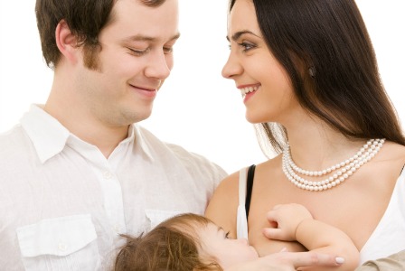 mom breastfeeding baby and dad