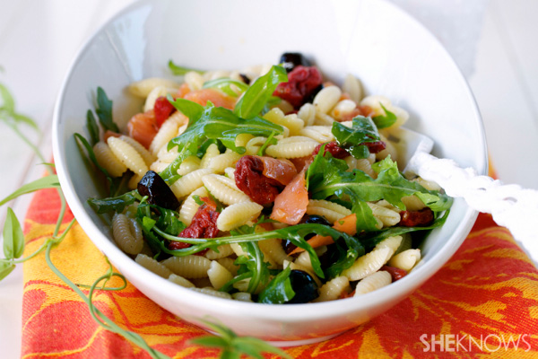 Cold pasta salad with smoked salmon, sun-dried tomatoes and olives