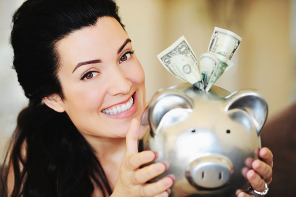 Smiling woman saving money