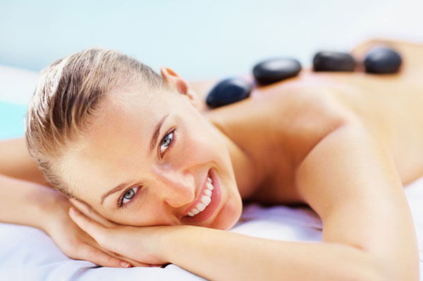 Relaxed woman getting stone therapy | Sheknows.com