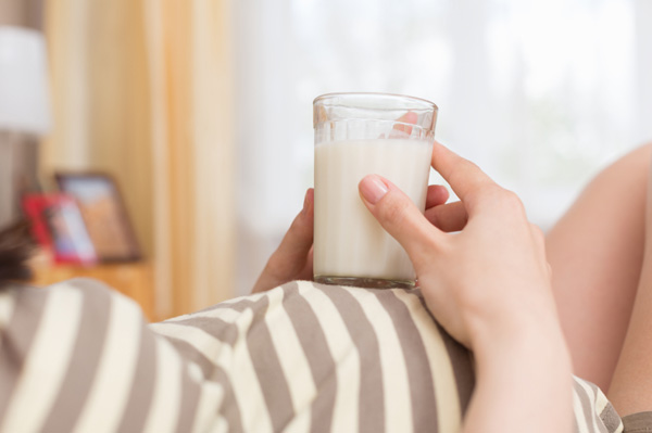 Pregnant woman drinking milk