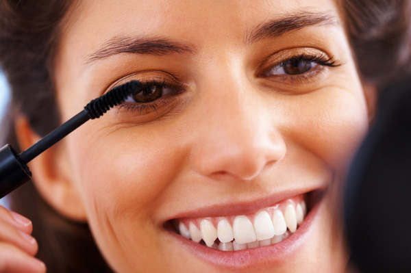 Woman applying mascara