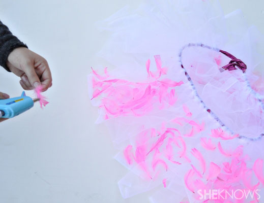 Flamingo costume Step 4: Glue feathers on your tulle
