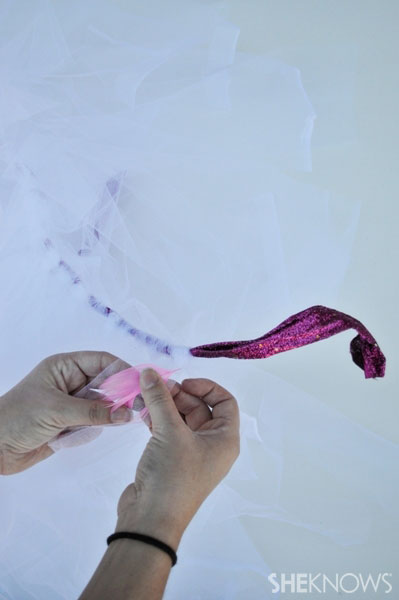 Flamingo costume Step 4: Glue feathers on your tulle