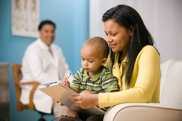 Mother filling out form at doctor's office