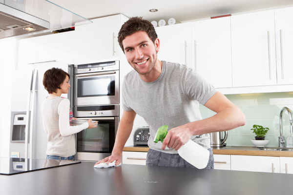 Couple cleaning kitchen