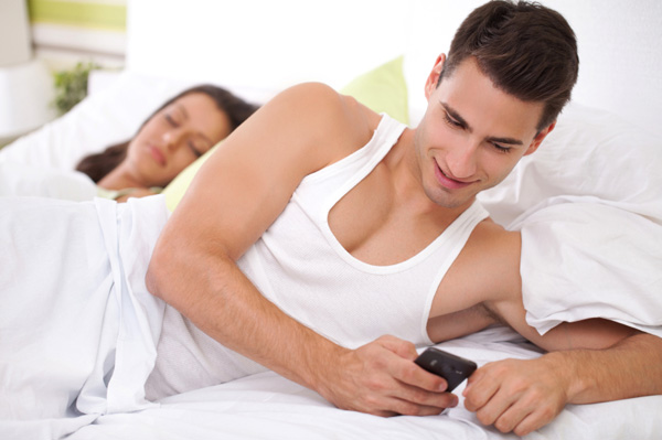 [Image: man-texting-while-in-bed-with-woman.jpg]