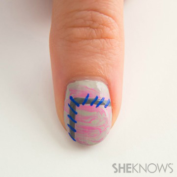 A nail design outlined in stitches