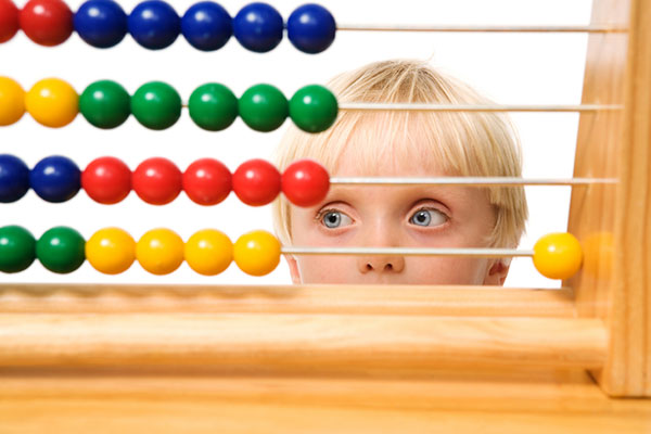 Child thinking hard about toy | Sheknows.com