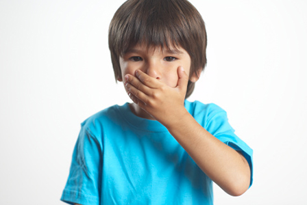Boy covering mouth | Sheknows.com