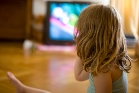 Young girl watching television | Sheknows.com