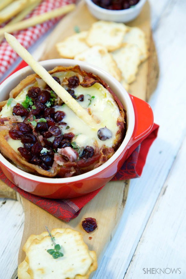 Bacon-wrapped baked Brie with thyme and cranberry sauce