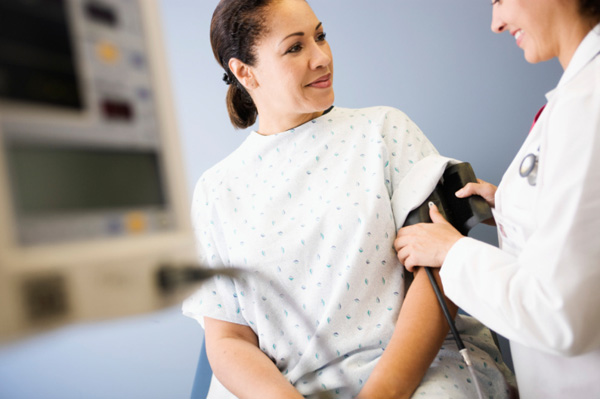 Woman having blood pressure tested