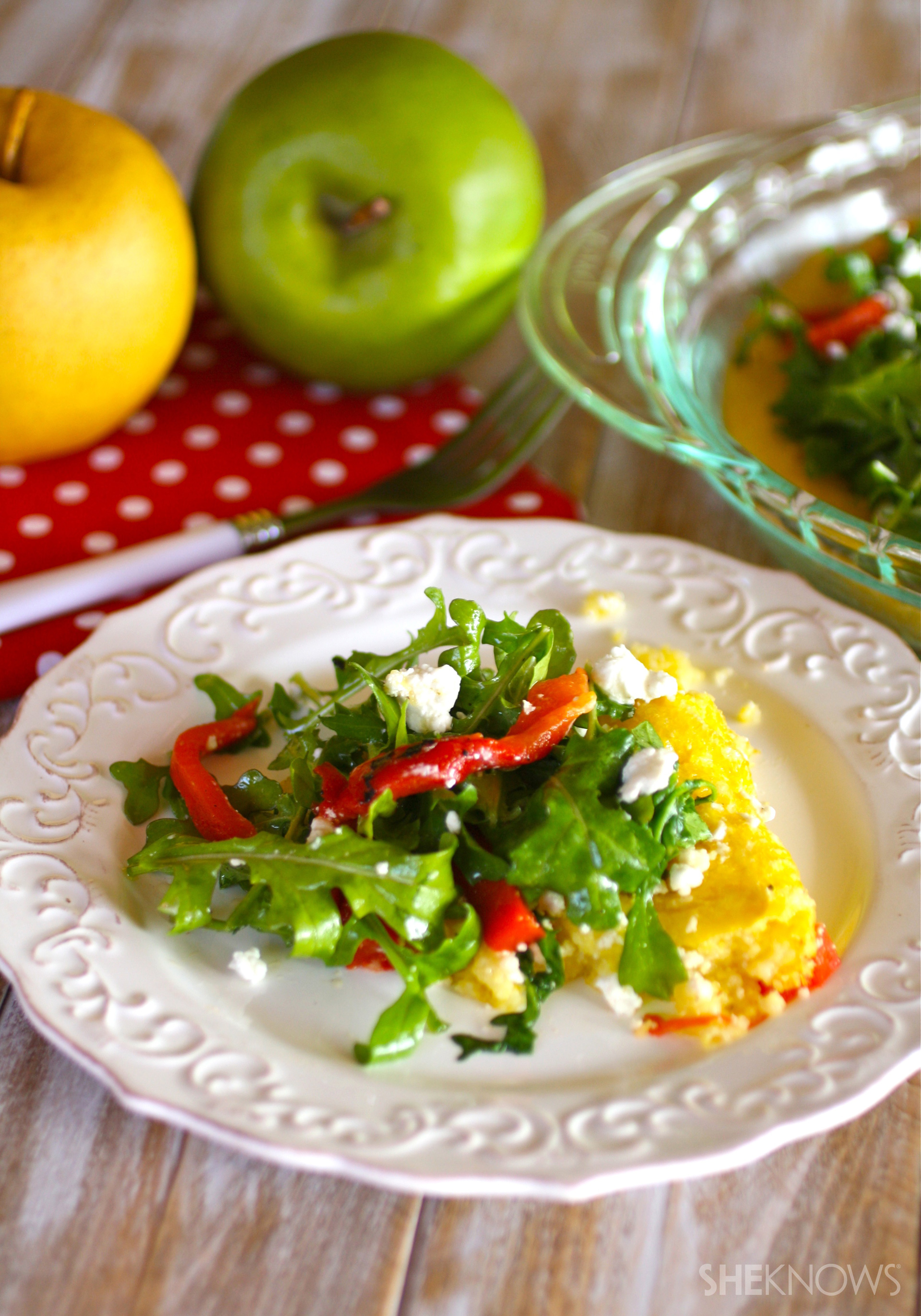 Gluten-free polenta pie with arugula, roasted red peppers and goat cheese
