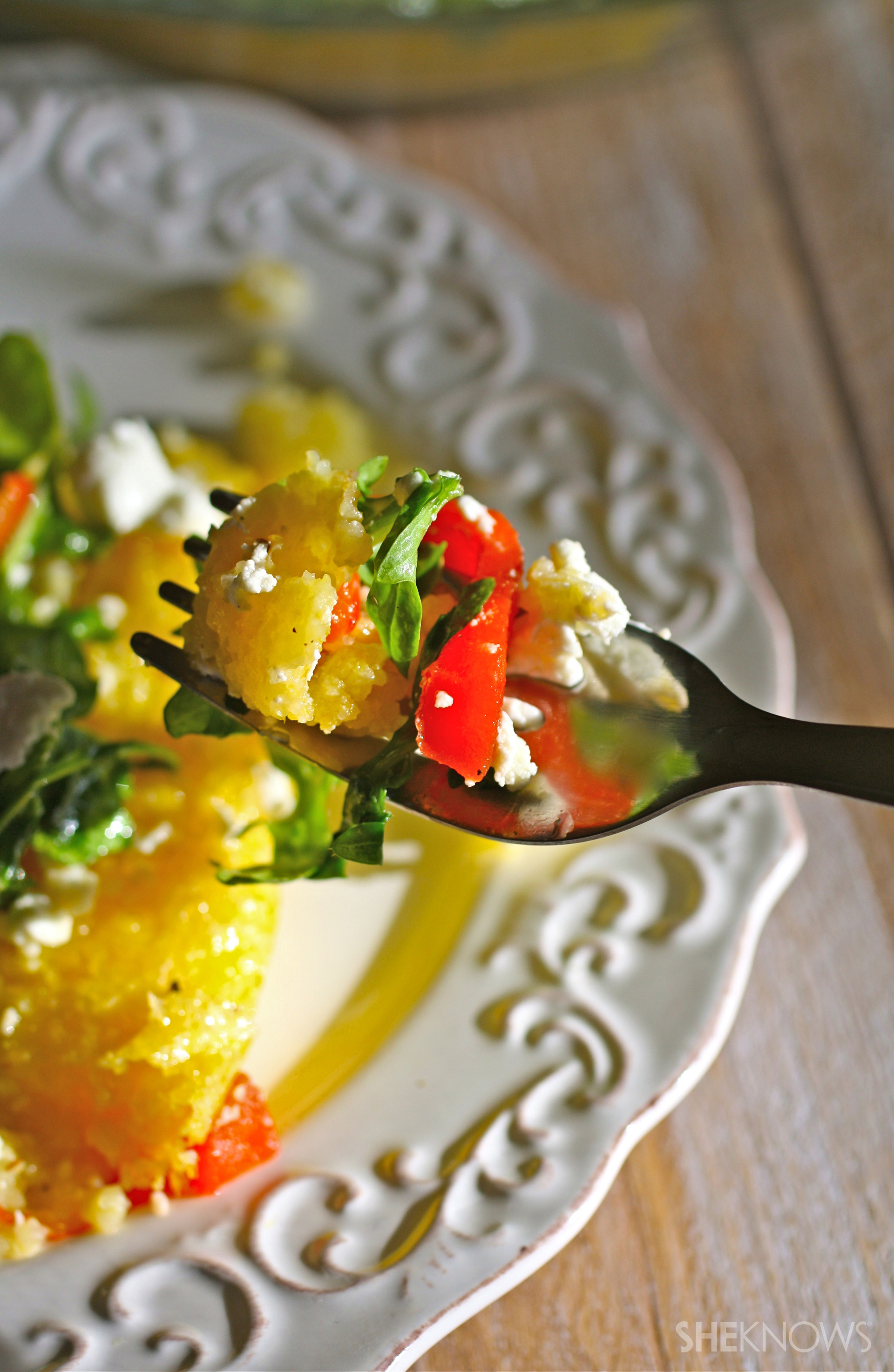 Gluten-free polenta pie with arugula, roasted red peppers and goat cheese