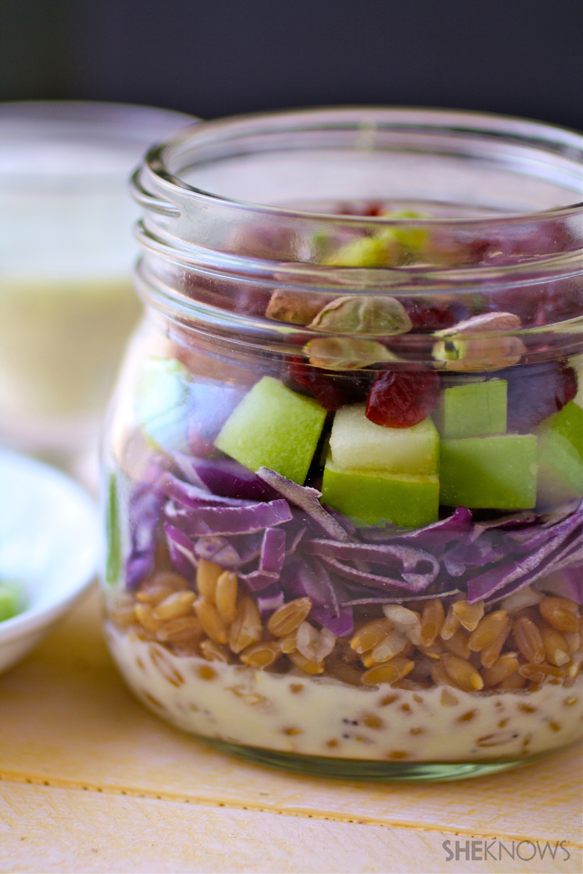 Mason jar salad with farro, cabbage and apples and poppy seed dressing