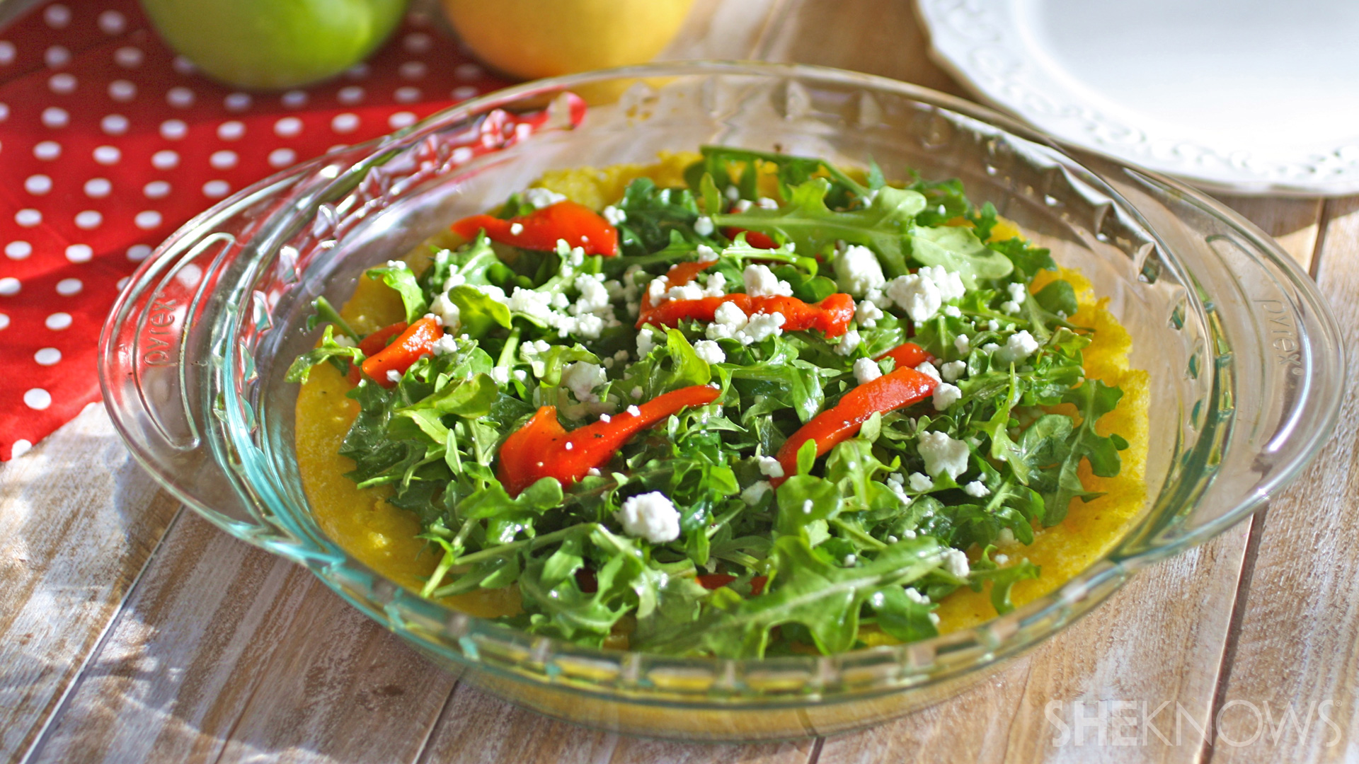 Gluten-free polenta pie with arugula, roasted red peppers and goat cheese