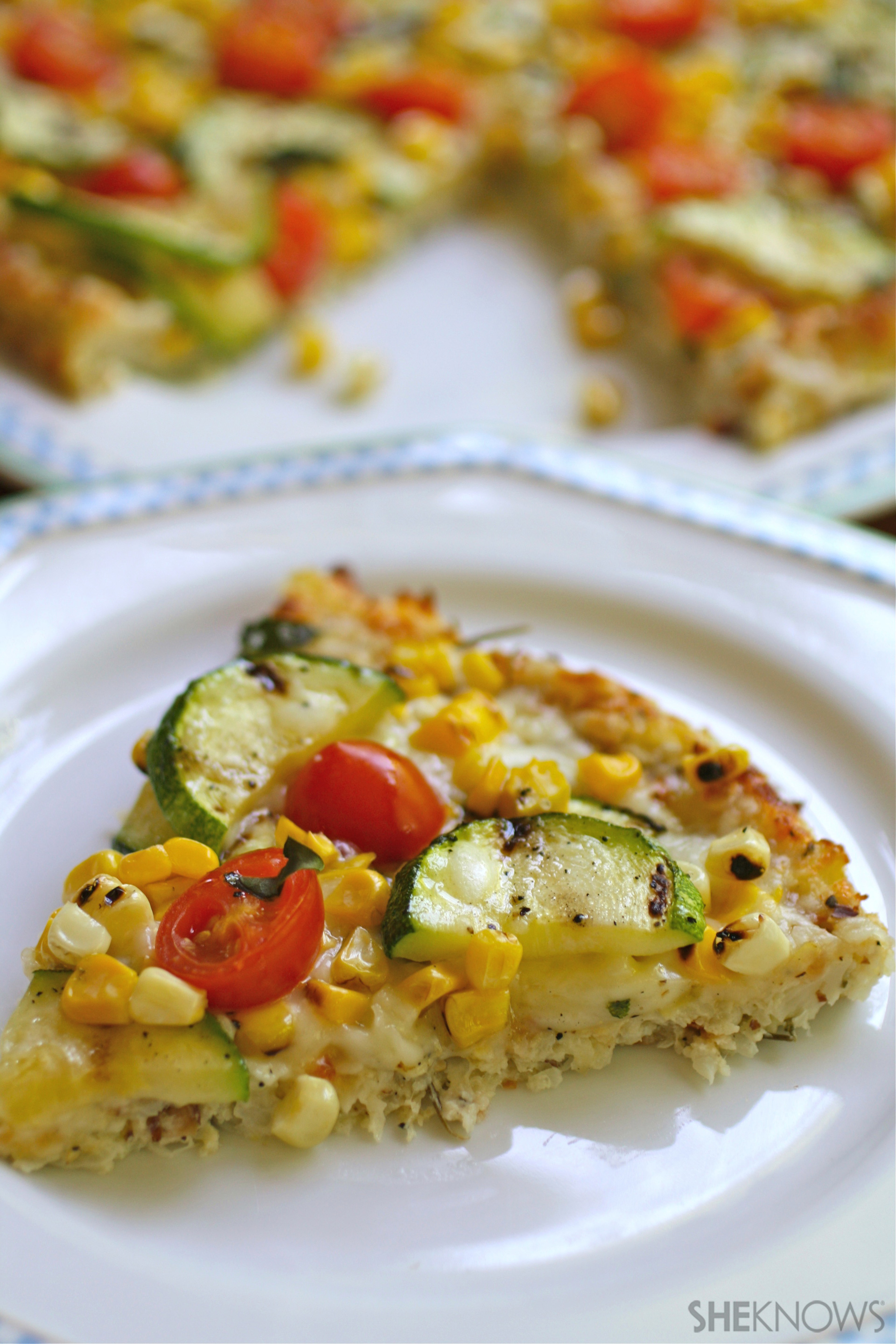 Cauliflower crust pizza with grilled corn, zucchini, and tomatoes