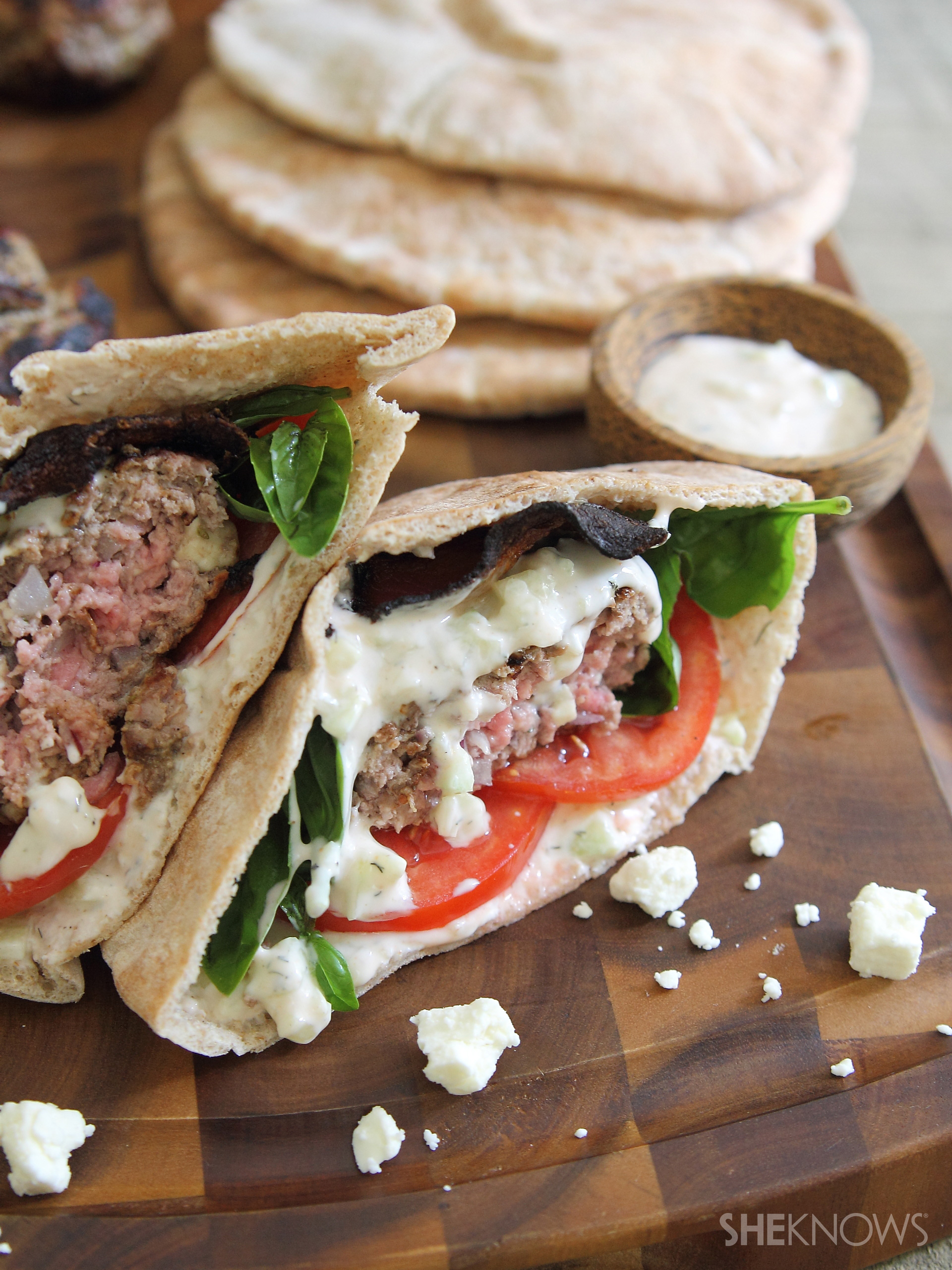 Fetastuffed lamb and bacon pita burgers with spicy tzatziki sauce