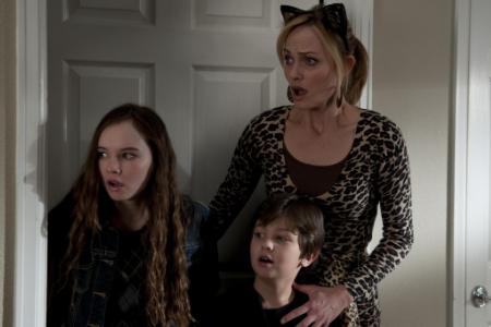 The Spy Next Door stars Amber Valletta as a mom of three kids in need of saving by Jackie Chan