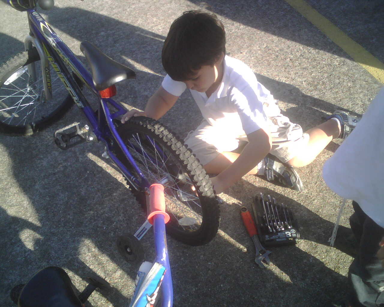 My son working on his bike.