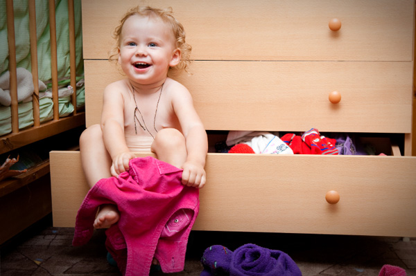 Baby girl trying on clothes