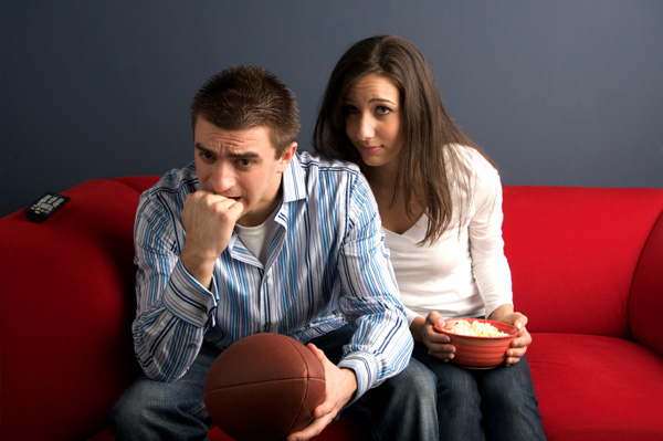 Bored woman watching football