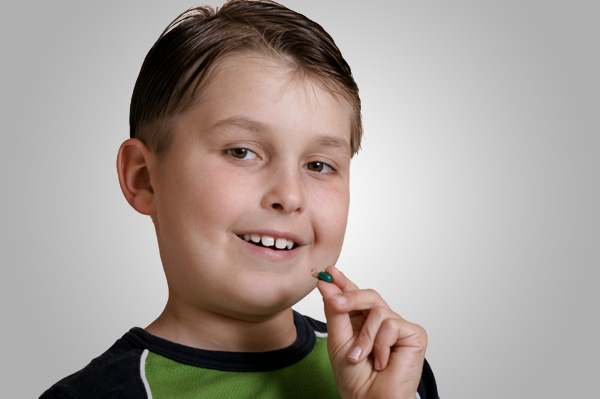 Boy taking vitamin pill