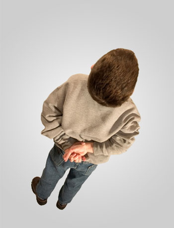 Boy with fingers crossed behind back