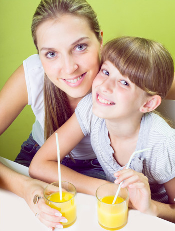 Mom and Daughter Drinking Orange Juice