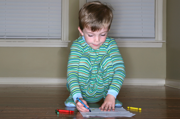 Child coloring in pajamas