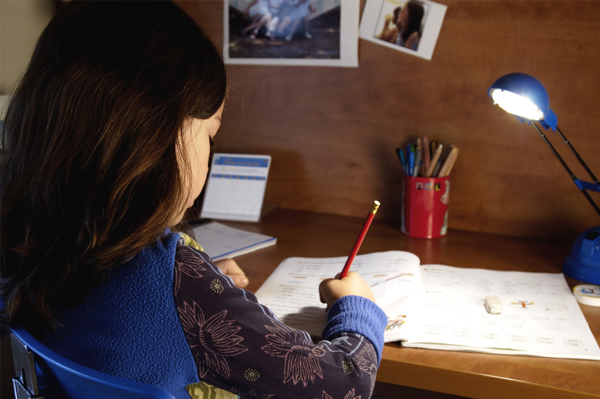 Child doing homework at desk