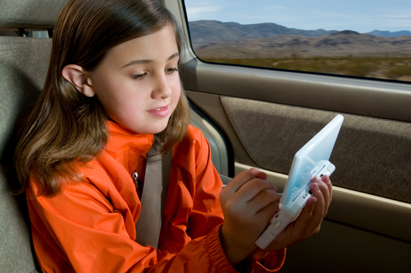 child-playing-han-held-video-game-in-car