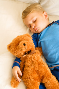 Child sleeping with teddybear
