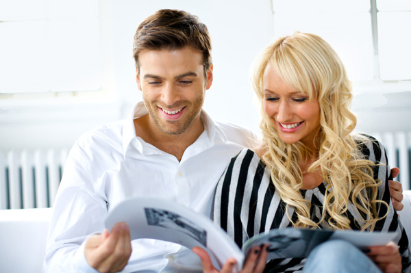 Couple reading magazine