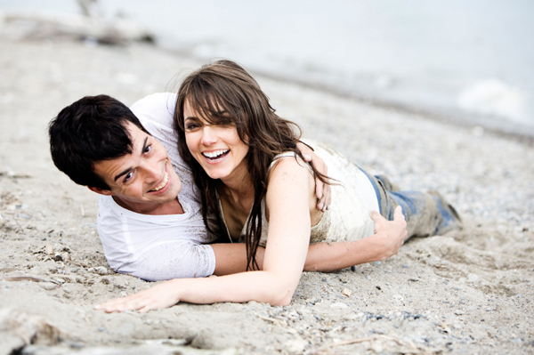 Couple rolling in sand