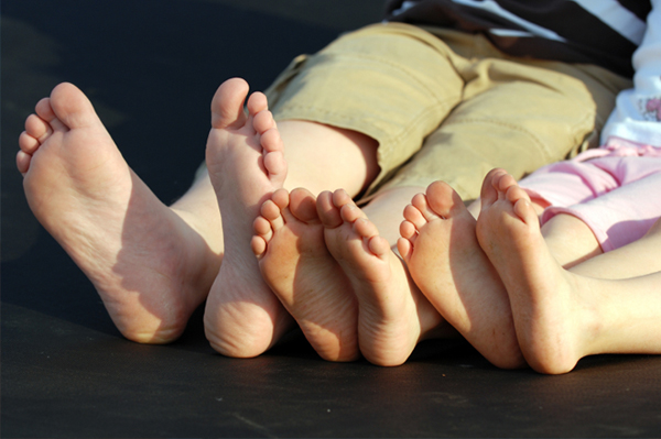 The feet of a brother and his two sisters