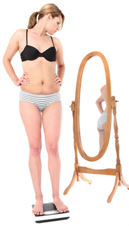 Woman in Bikini Looking at Mirror