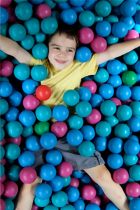 Young boy in ball pit.
