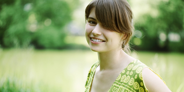 Woman dressed in green outdoors.