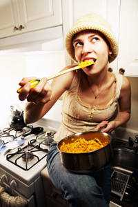 Woman eating macaroni and cheese.