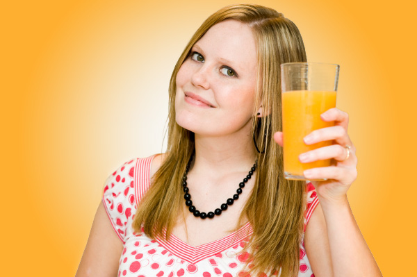 Woman with a glass of orange juice.