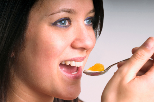 Woman eating Yogurt and Fruit