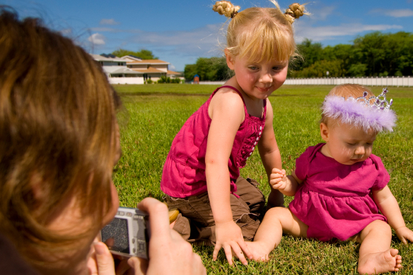 Mom taking pictures of daughters