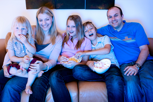 Family watching musical on tv