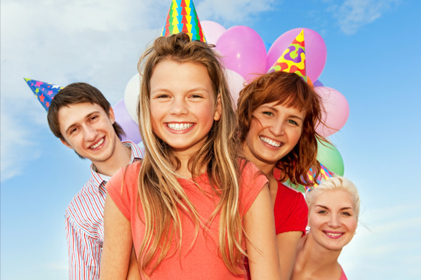 Girl and family wearing party hats
